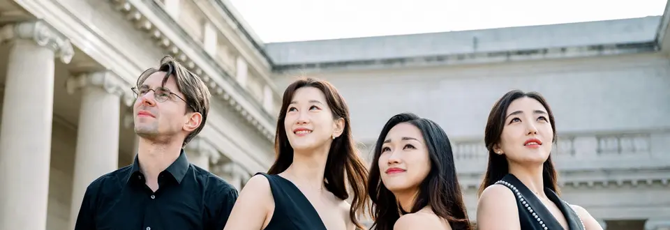 Members of the Esme Quartet outside, looking up at the sky.