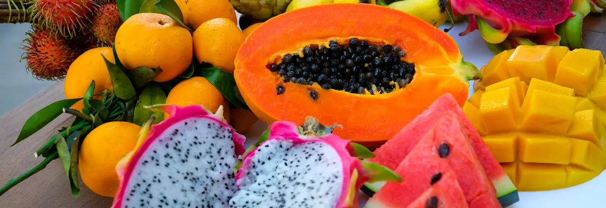 Fruit platter with exotic tropical fruits. watermelon papaya pitahaya rambutan sugar apple tangerines mango bananas