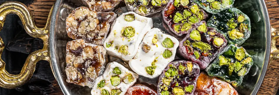 Turkish Delight Lukum, a national dessert. Black background. Top view.